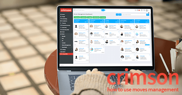 The Crimson Feature of the Month for May 2022 is Moves Management. In the photo, a person sits at a table with a MacBook Pro open. On the screen is the Moves Management dashboard in Crimson. 